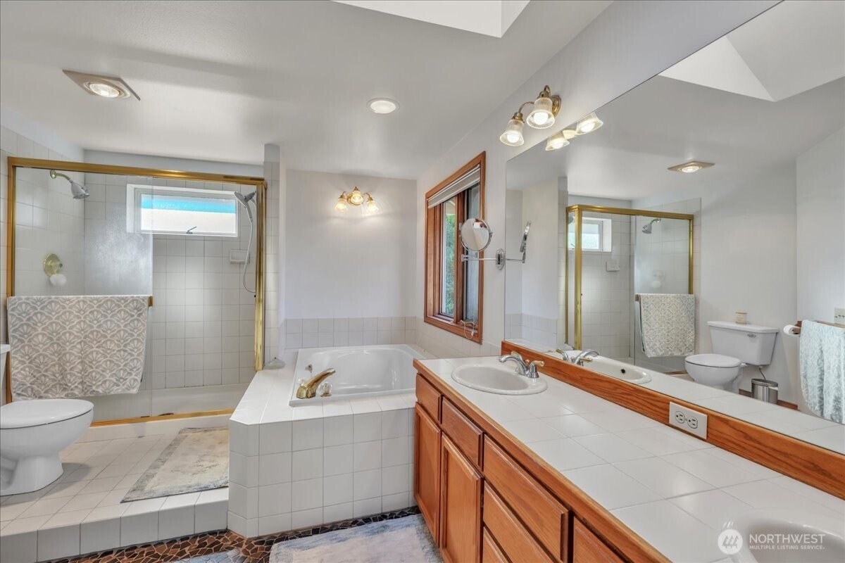 7929 Cyrus Place Edmonds, WA 98026 - Photo 21 of 34 a spacious bathroom with a granite countertop sink mirror and toilet