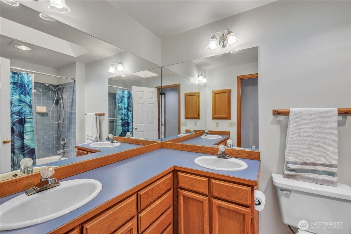 7929 Cyrus Place Edmonds, WA 98026 - Photo 22 of 34 a bathroom with a sink double vanity and a mirror