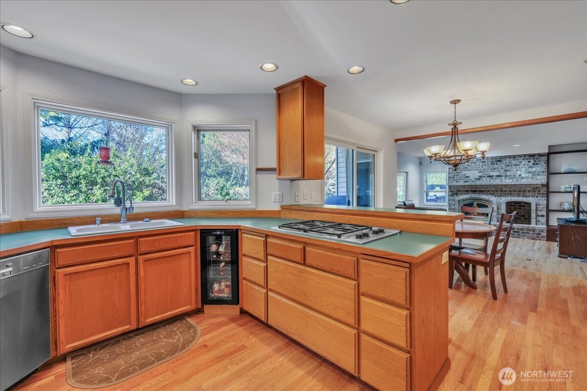 7929 Cyrus Place Edmonds, WA 98026 - Photo 7 of 34 a kitchen with kitchen island granite countertop wooden floors and a view of living room