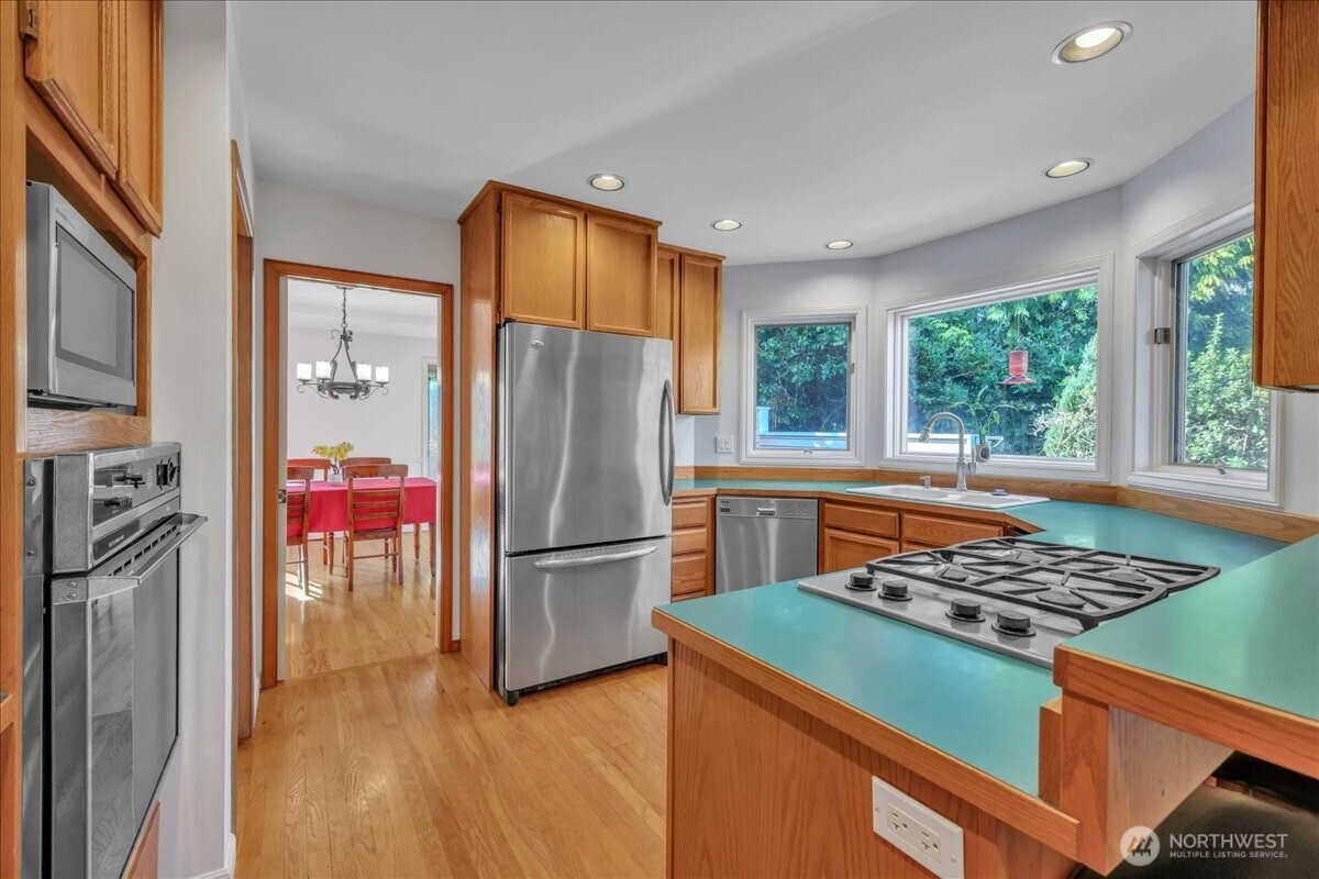 7929 Cyrus Place Edmonds, WA 98026 - Photo 8 of 34 a kitchen with a refrigerator a stove and a sink