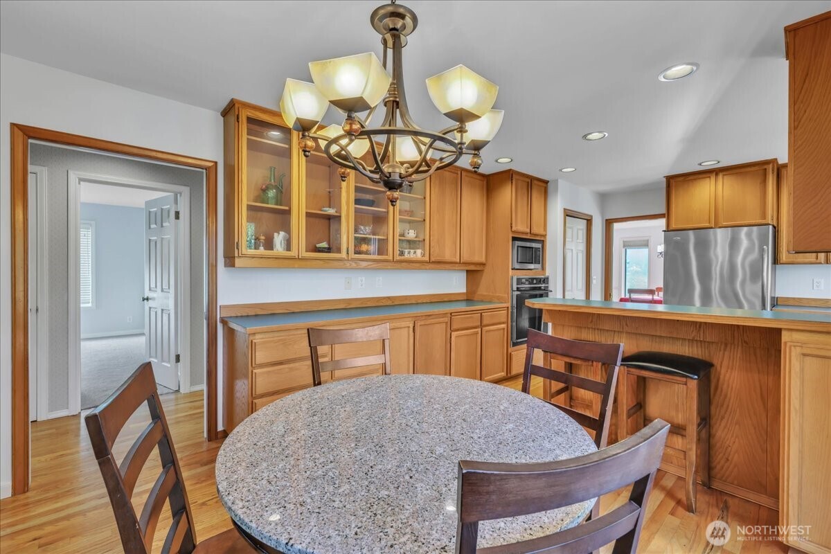 7929 Cyrus Place Edmonds, WA 98026 - Photo 10 of 34 a view of a dining room with furniture and wooden floor