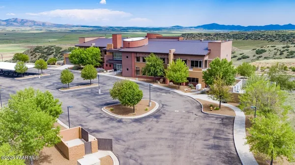 an aerial view of residential houses with outdoor space and ocean view