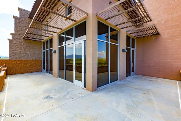 a large white kitchen with stainless steel appliances a sink and a large window