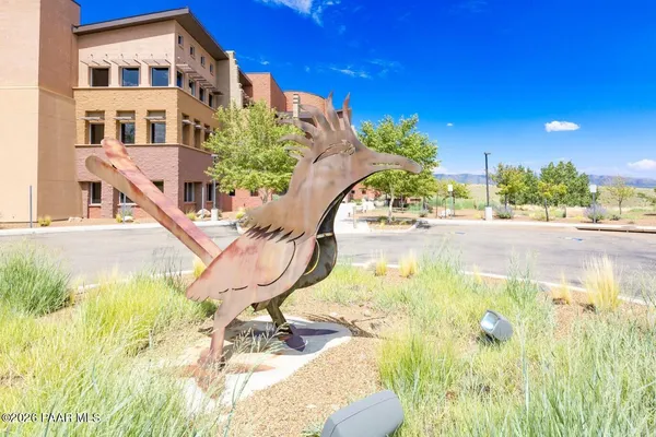 a front view of a house with outdoor seating and plants