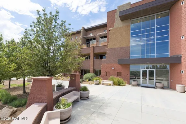 a tall building with trees in front of it