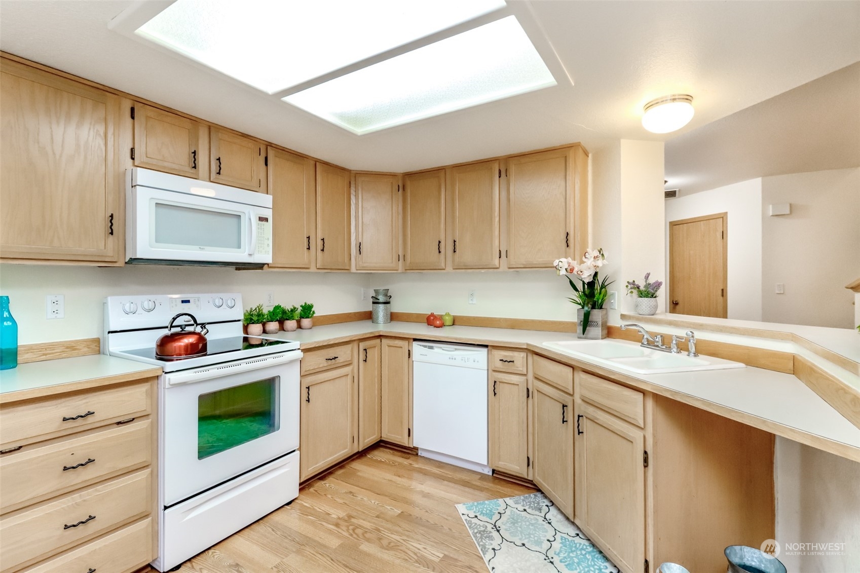 4566 Beckonridge Loop Southeast Lacey, WA 98513 - Photo 12 of 37 a kitchen with a sink stove top oven and cabinets