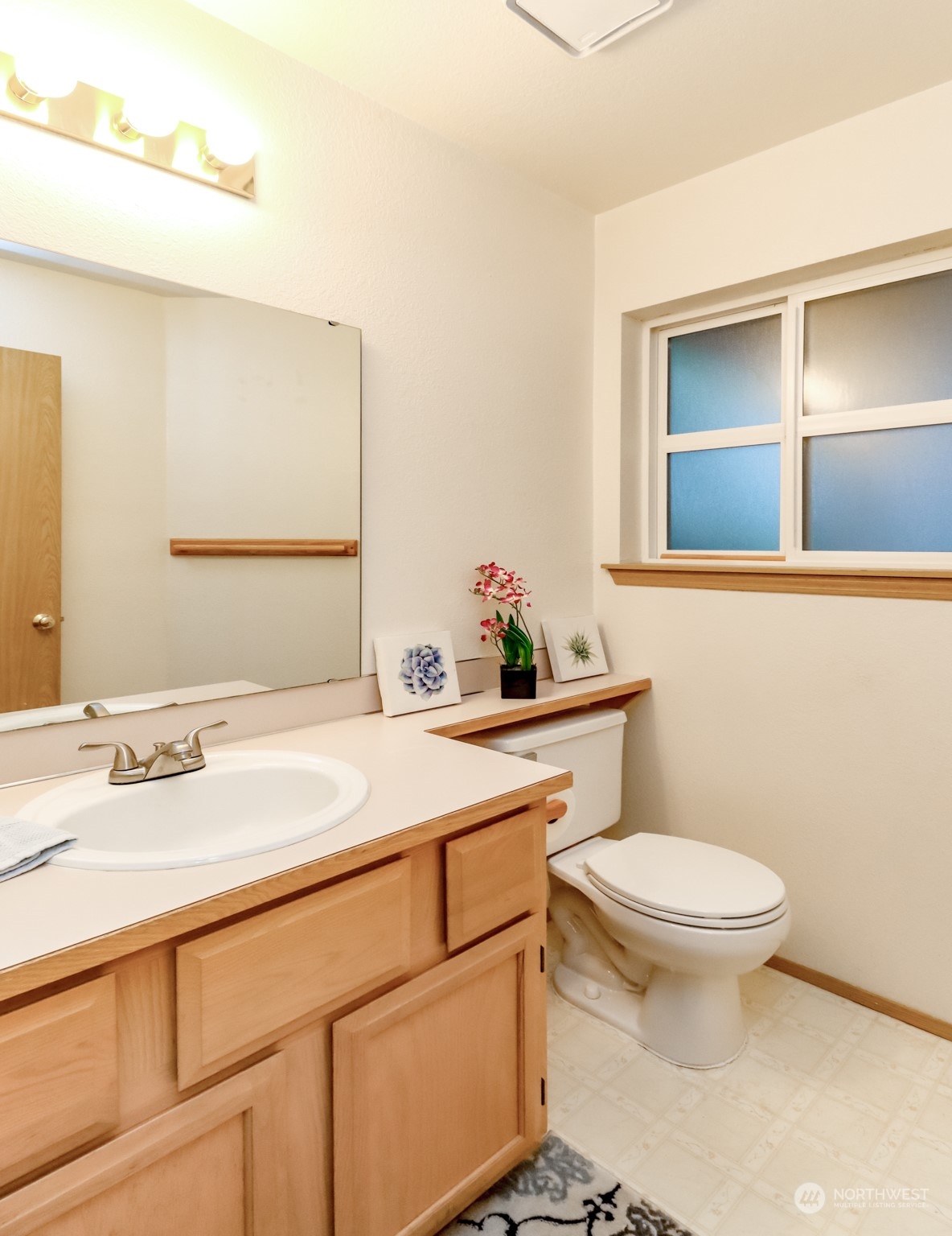 4566 Beckonridge Loop Southeast Lacey, WA 98513 - Photo 16 of 37 a bathroom with a sink toilet and mirror