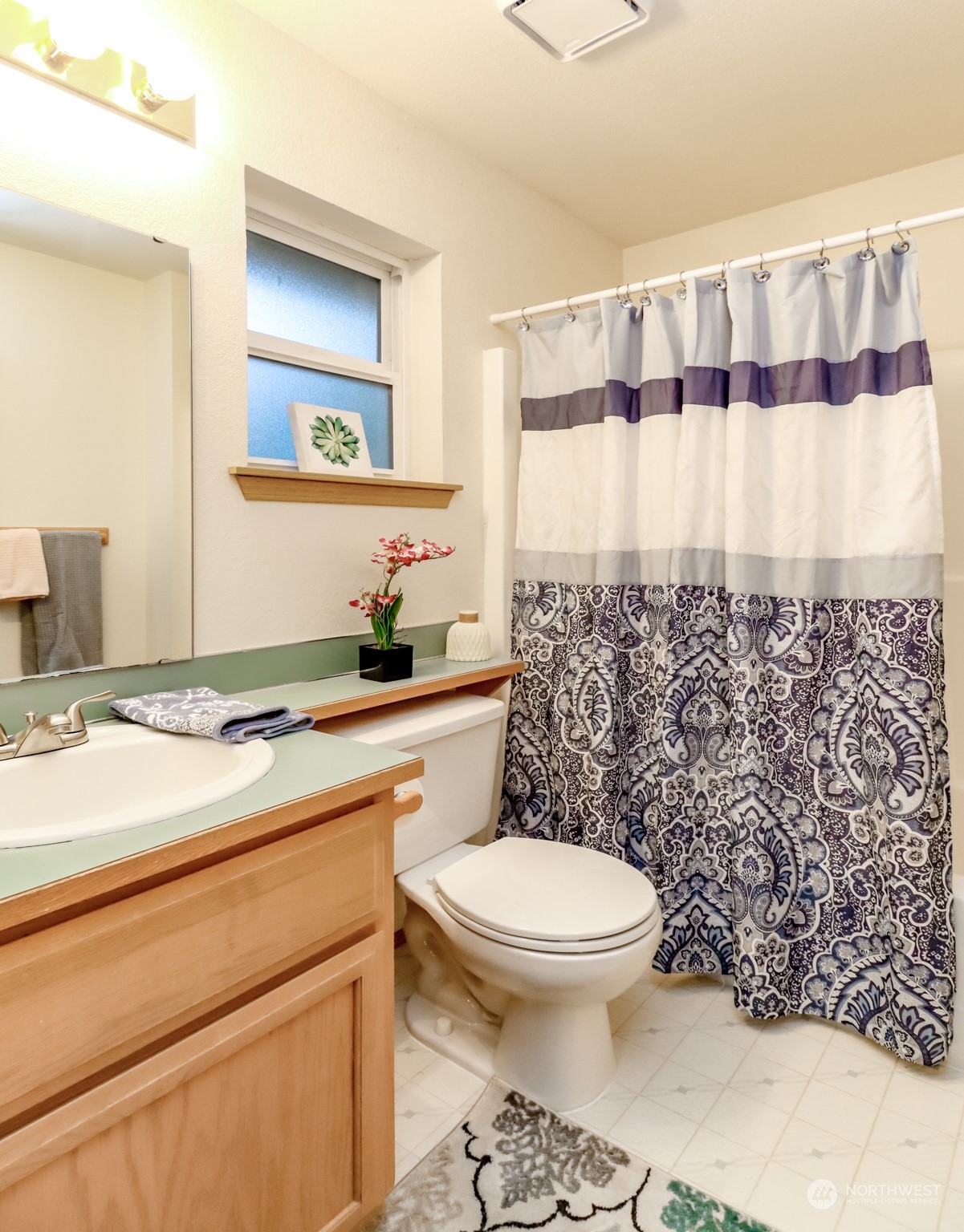 4566 Beckonridge Loop Southeast Lacey, WA 98513 - Photo 28 of 37 a bathroom with a granite countertop toilet a sink and a mirror