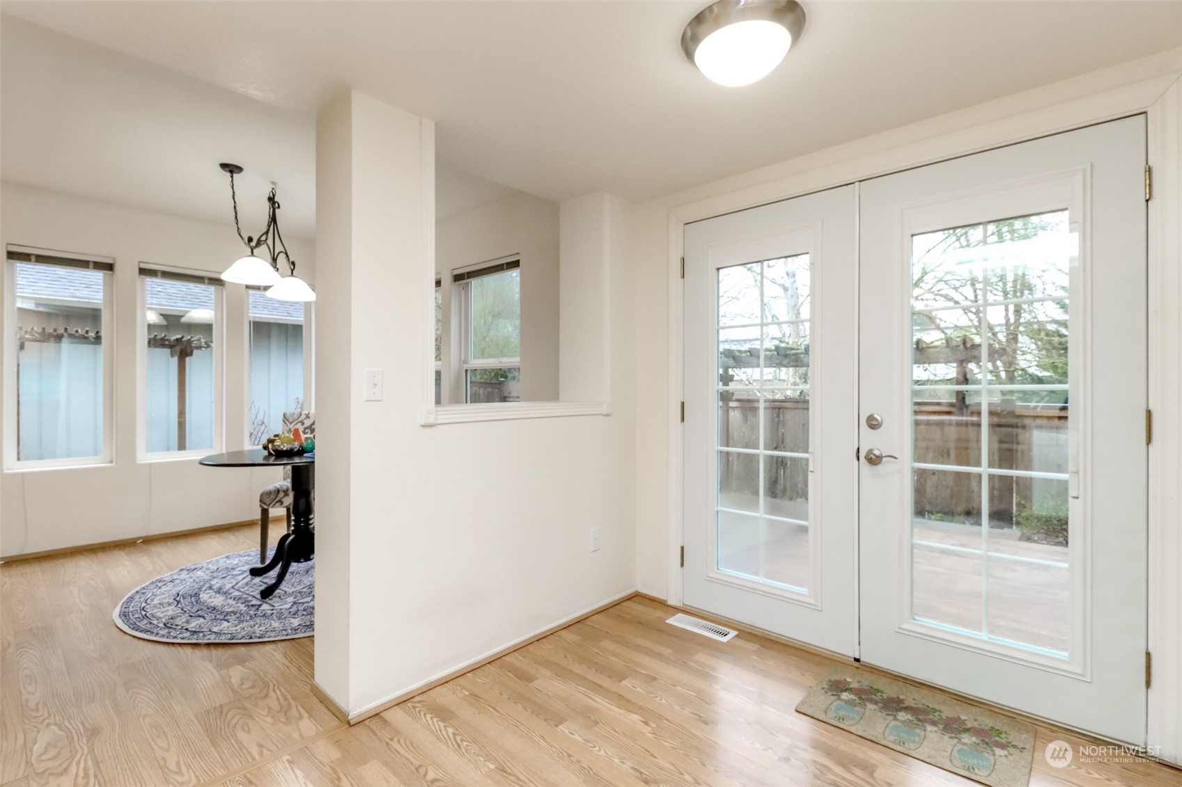 4566 Beckonridge Loop Southeast Lacey, WA 98513 - Photo 10 of 37 a view of a livingroom with wooden floor and a large window