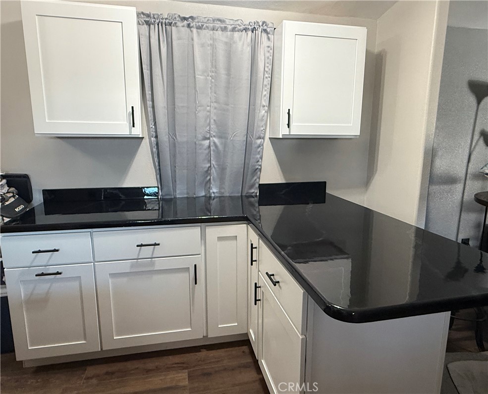 50918 Parker Dam Road, Unit 121 Earp, CA 92242 - Photo 13 of 24 a kitchen with granite countertop a sink a stove and cabinets