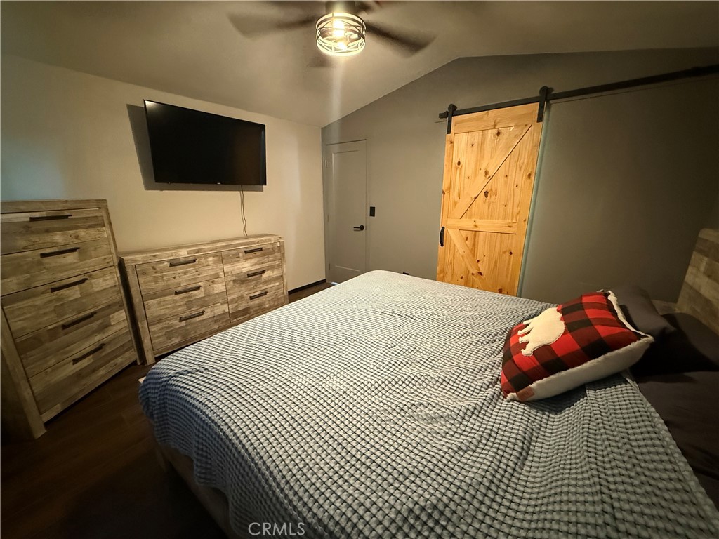50918 Parker Dam Road, Unit 121 Earp, CA 92242 - Photo 14 of 24 a bedroom with a bed and a flat screen tv