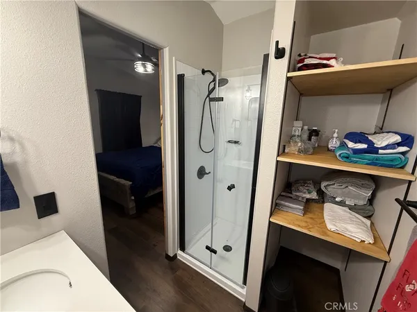 a bed sitting in a bedroom next to a window