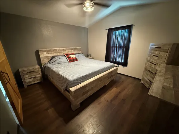 a bedroom with a bed and a dresser