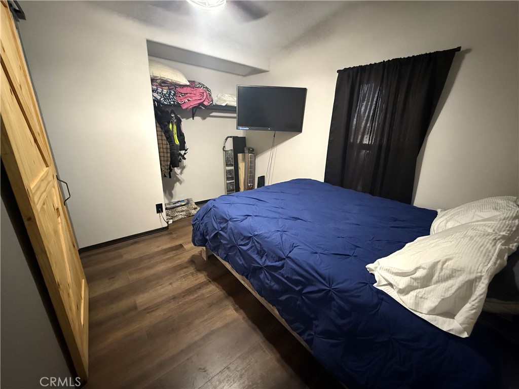 50918 Parker Dam Road, Unit 121 Earp, CA 92242 - Photo 19 of 24 a bedroom with a bed and a flat tv screen on the dresser