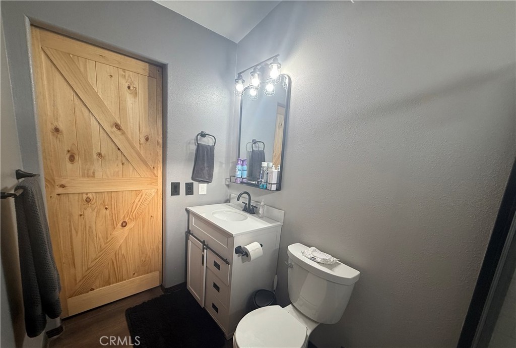 50918 Parker Dam Road, Unit 121 Earp, CA 92242 - Photo 20 of 24 a bathroom with a toilet sink and mirror
