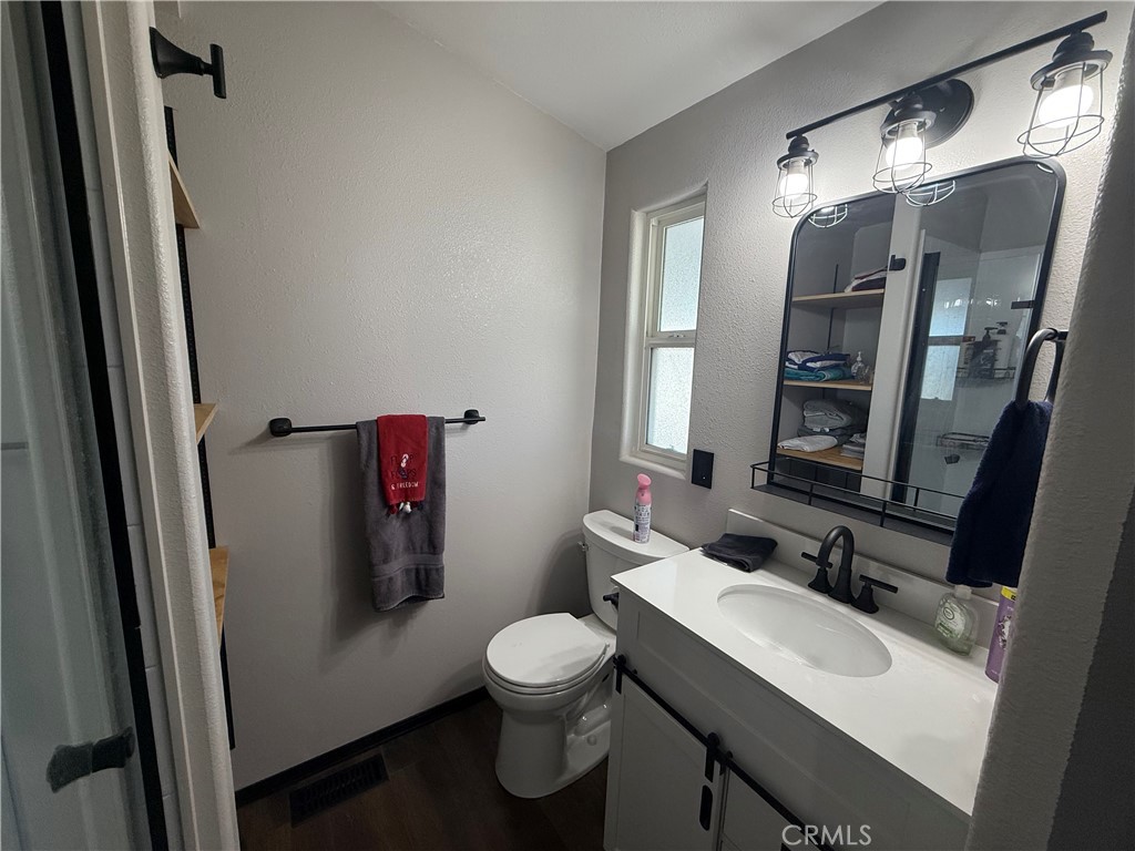 50918 Parker Dam Road, Unit 121 Earp, CA 92242 - Photo 22 of 24 a bathroom with a sink vanity mirror and toilet