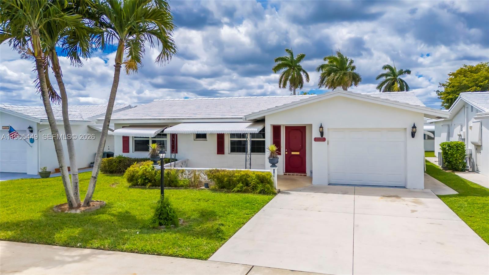 1005 Southwest 18th Street Boynton Beach, FL 33426 - Photo 1 of 44 a front view of house with yard and green space
