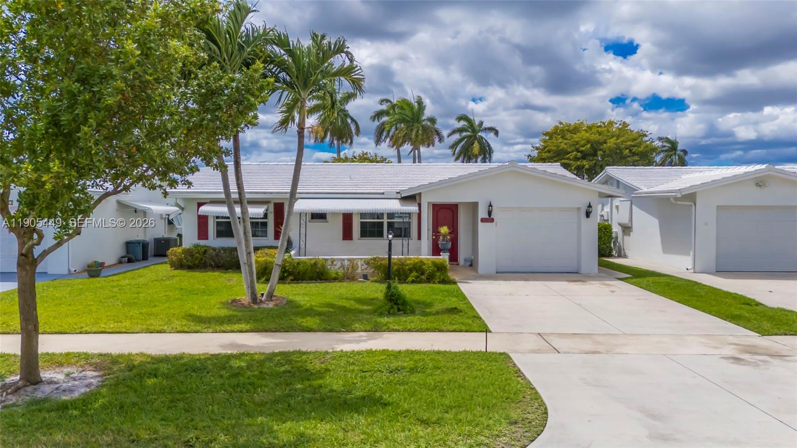 1005 Southwest 18th Street Boynton Beach, FL 33426 - Photo 2 of 44 a front view of a house with a yard