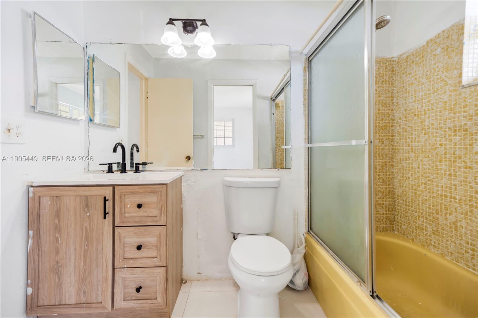 1005 Southwest 18th Street Boynton Beach, FL 33426 - Photo 21 of 44 a bathroom with a sink a toilet a mirror and shower