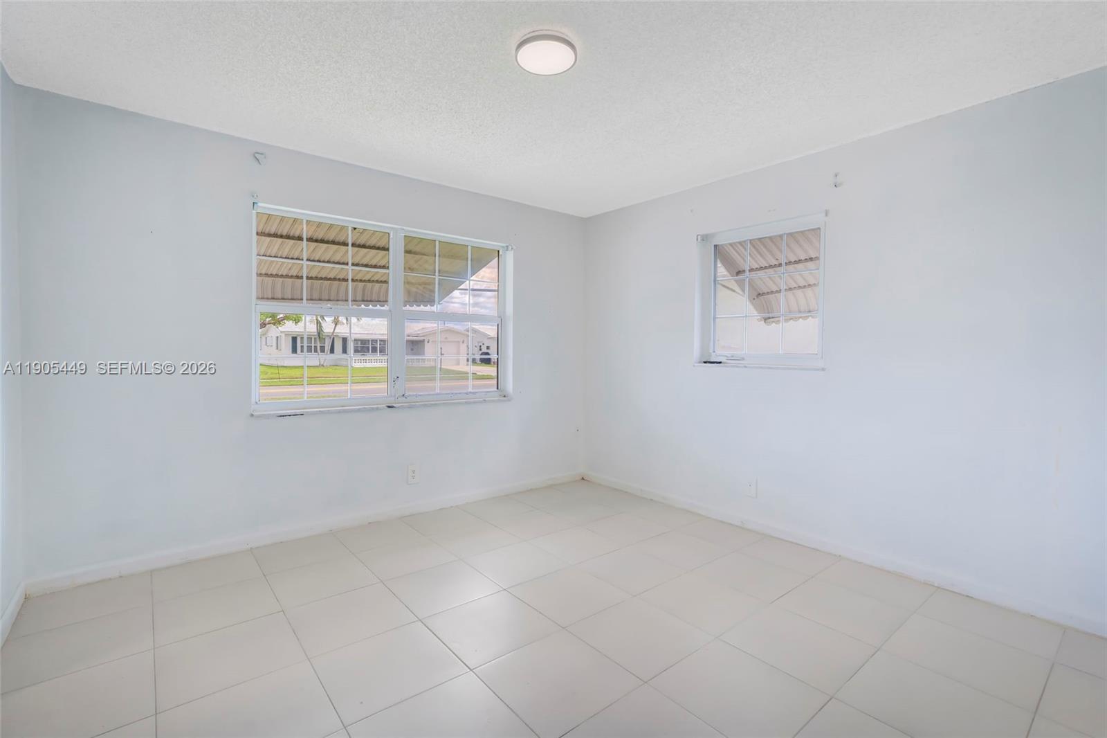 1005 Southwest 18th Street Boynton Beach, FL 33426 - Photo 22 of 44 an empty room with windows