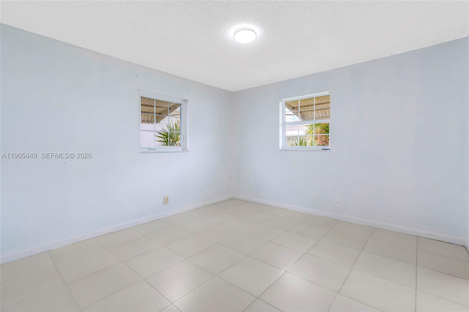 1005 Southwest 18th Street Boynton Beach, FL 33426 - Photo 24 of 44 an empty room with a window