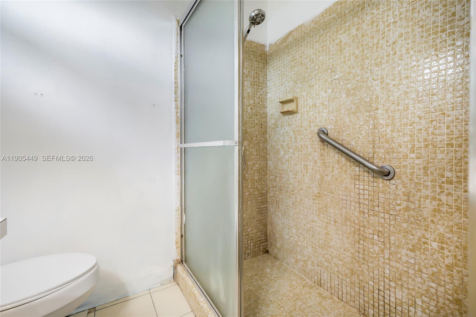 1005 Southwest 18th Street Boynton Beach, FL 33426 - Photo 29 of 44 a bathroom with a toilet and a shower
