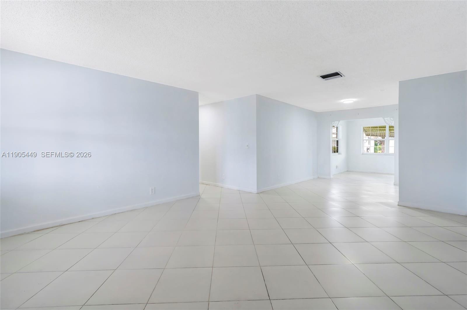 1005 Southwest 18th Street Boynton Beach, FL 33426 - Photo 3 of 44 an empty room with windows and entrance