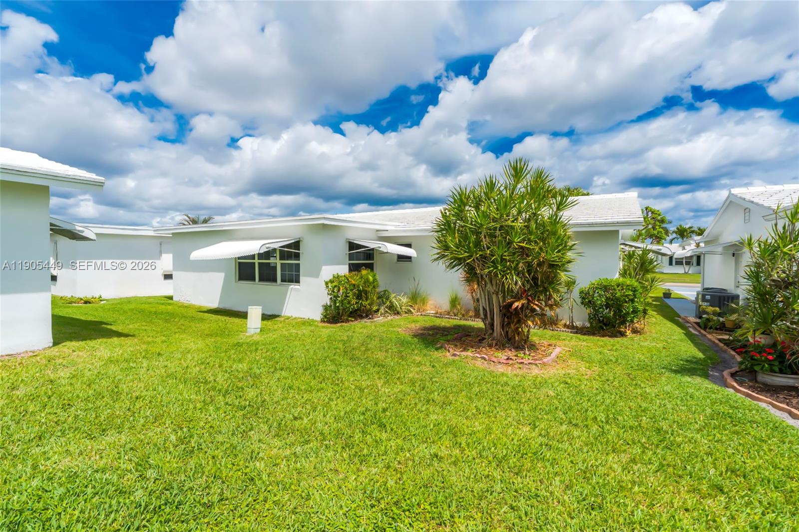 1005 Southwest 18th Street Boynton Beach, FL 33426 - Photo 31 of 44 a front view of a house with garden