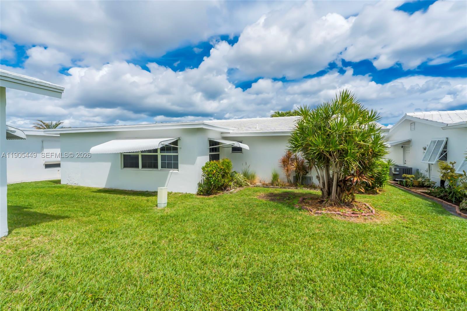 1005 Southwest 18th Street Boynton Beach, FL 33426 - Photo 32 of 44 a view of a house with a back yard