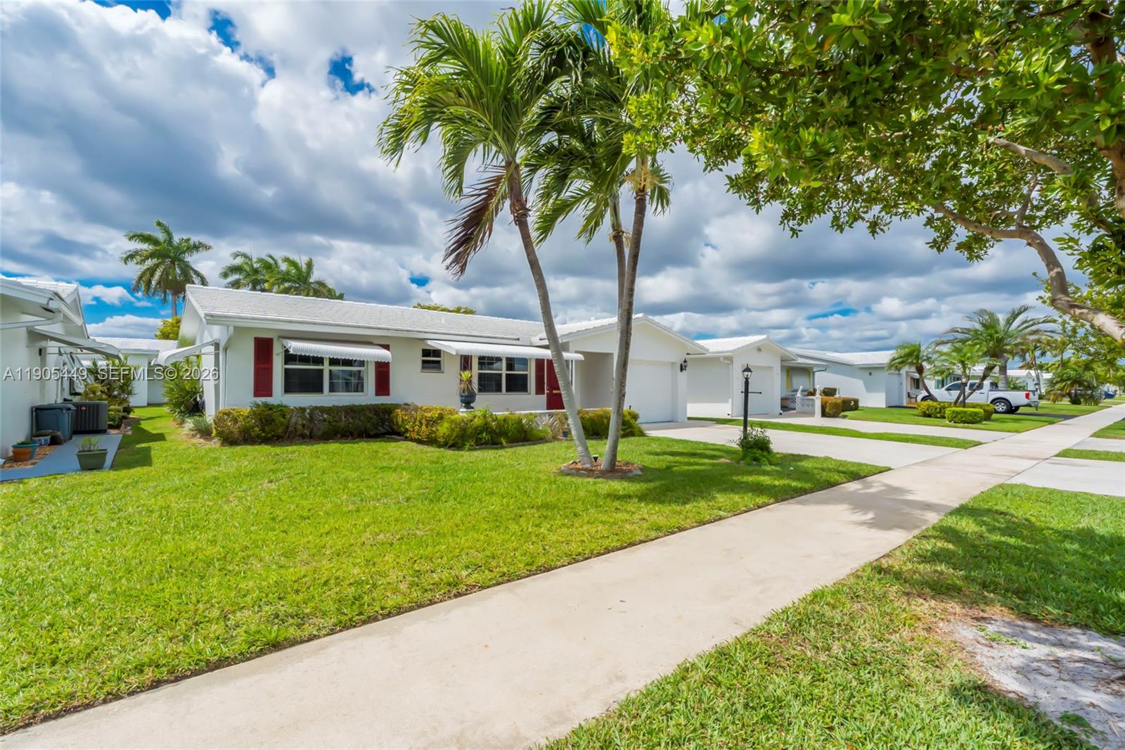 1005 Southwest 18th Street Boynton Beach, FL 33426 - Photo 34 of 44 a front view of a house with garden