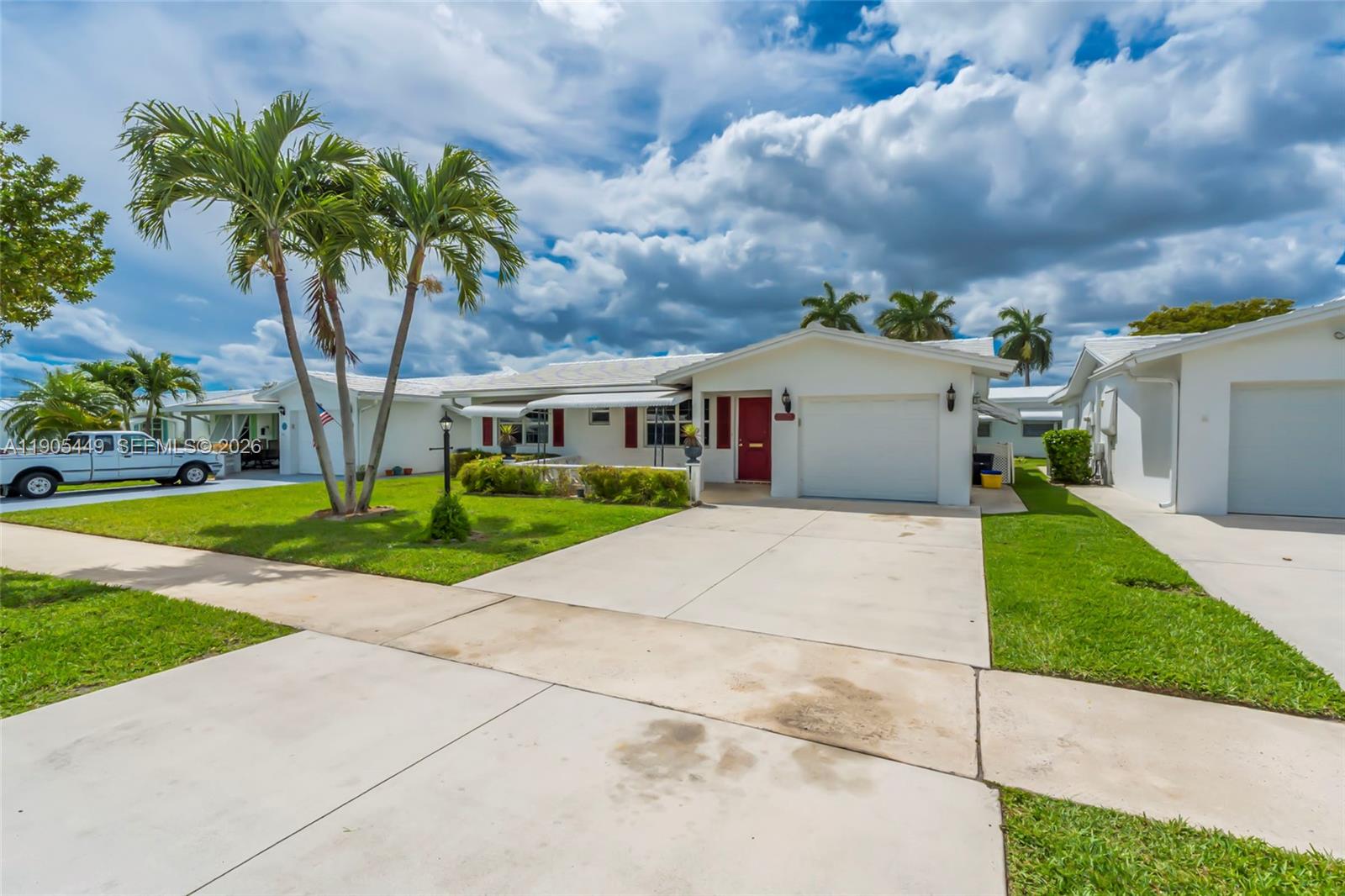 1005 Southwest 18th Street Boynton Beach, FL 33426 - Photo 35 of 44 a front view of house with yard and green space