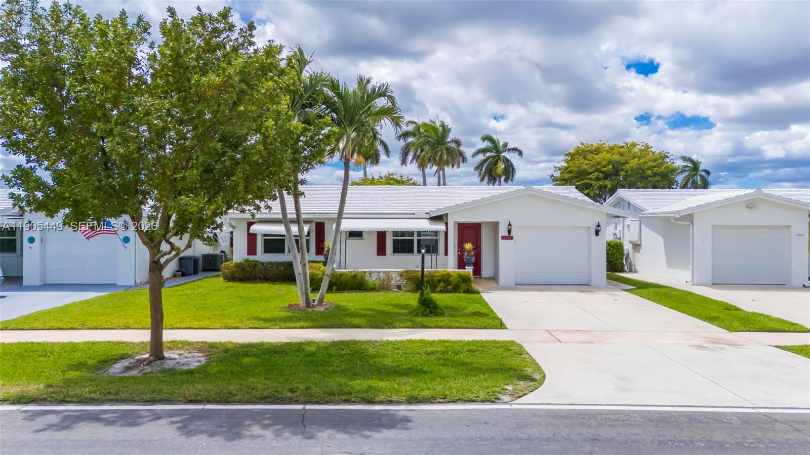 1005 Southwest 18th Street Boynton Beach, FL 33426 - Photo 38 of 44 a front view of a house with garden