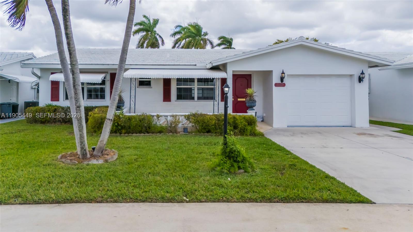 1005 Southwest 18th Street Boynton Beach, FL 33426 - Photo 43 of 44 a view front of house with a yard