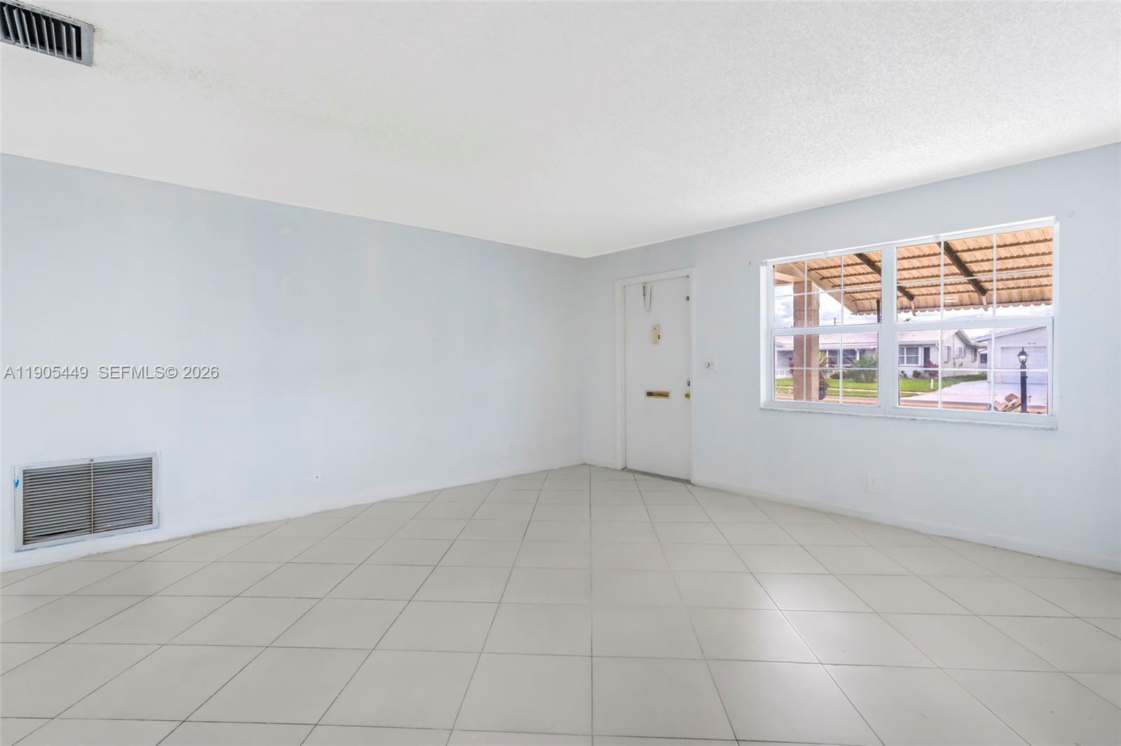 1005 Southwest 18th Street Boynton Beach, FL 33426 - Photo 5 of 44 an empty room with windows