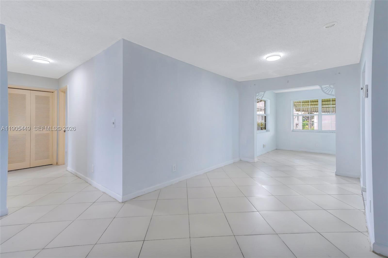 1005 Southwest 18th Street Boynton Beach, FL 33426 - Photo 7 of 44 a view of an empty room with a window