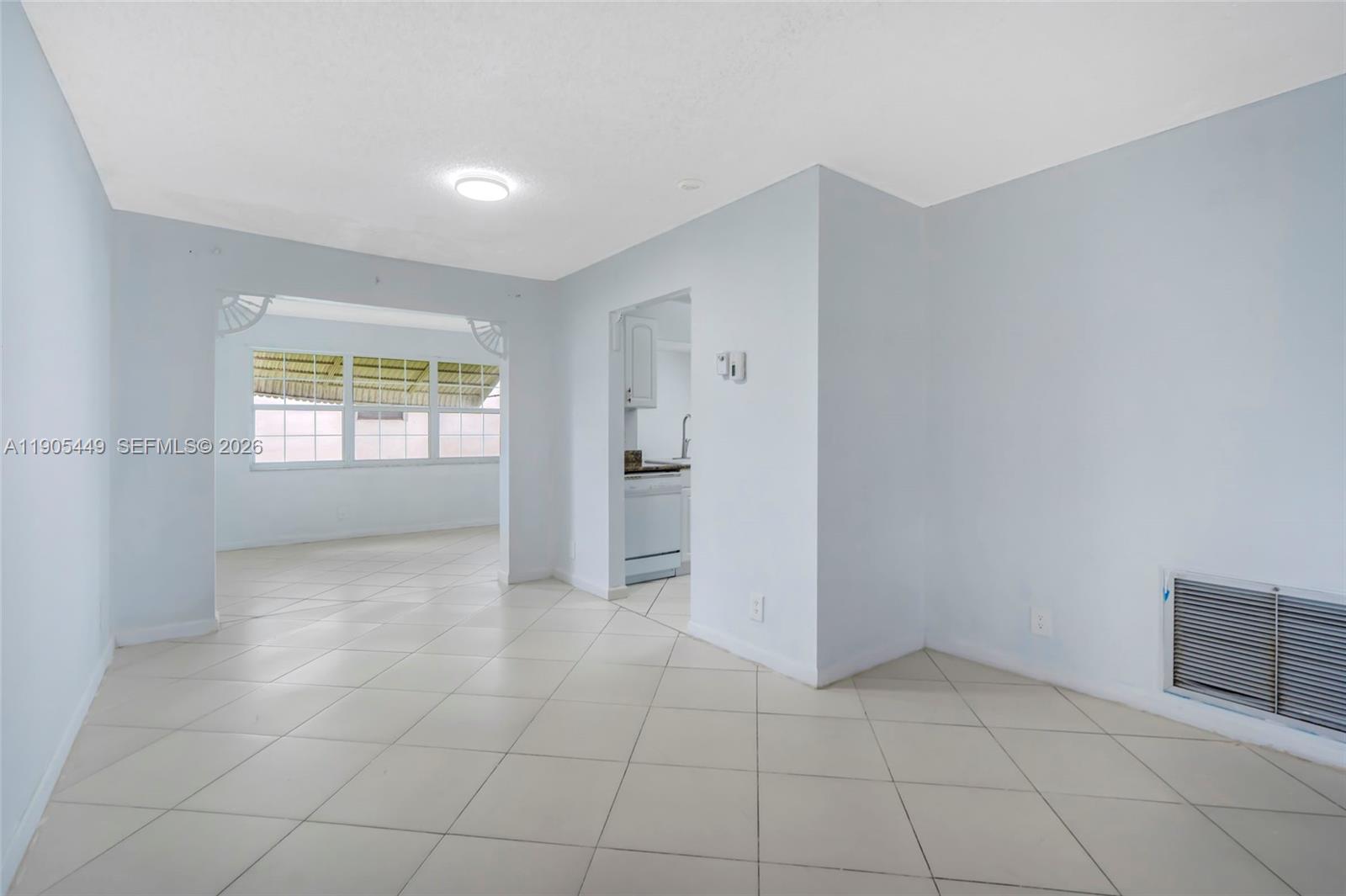 1005 Southwest 18th Street Boynton Beach, FL 33426 - Photo 8 of 44 a view of an empty room with a window