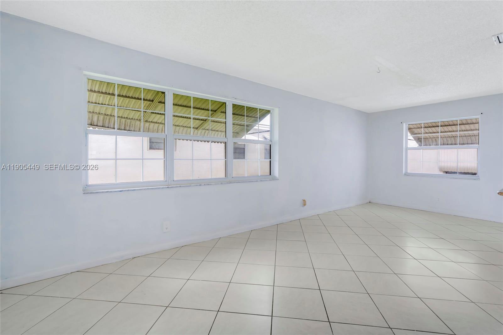 1005 Southwest 18th Street Boynton Beach, FL 33426 - Photo 9 of 44 an empty room with windows