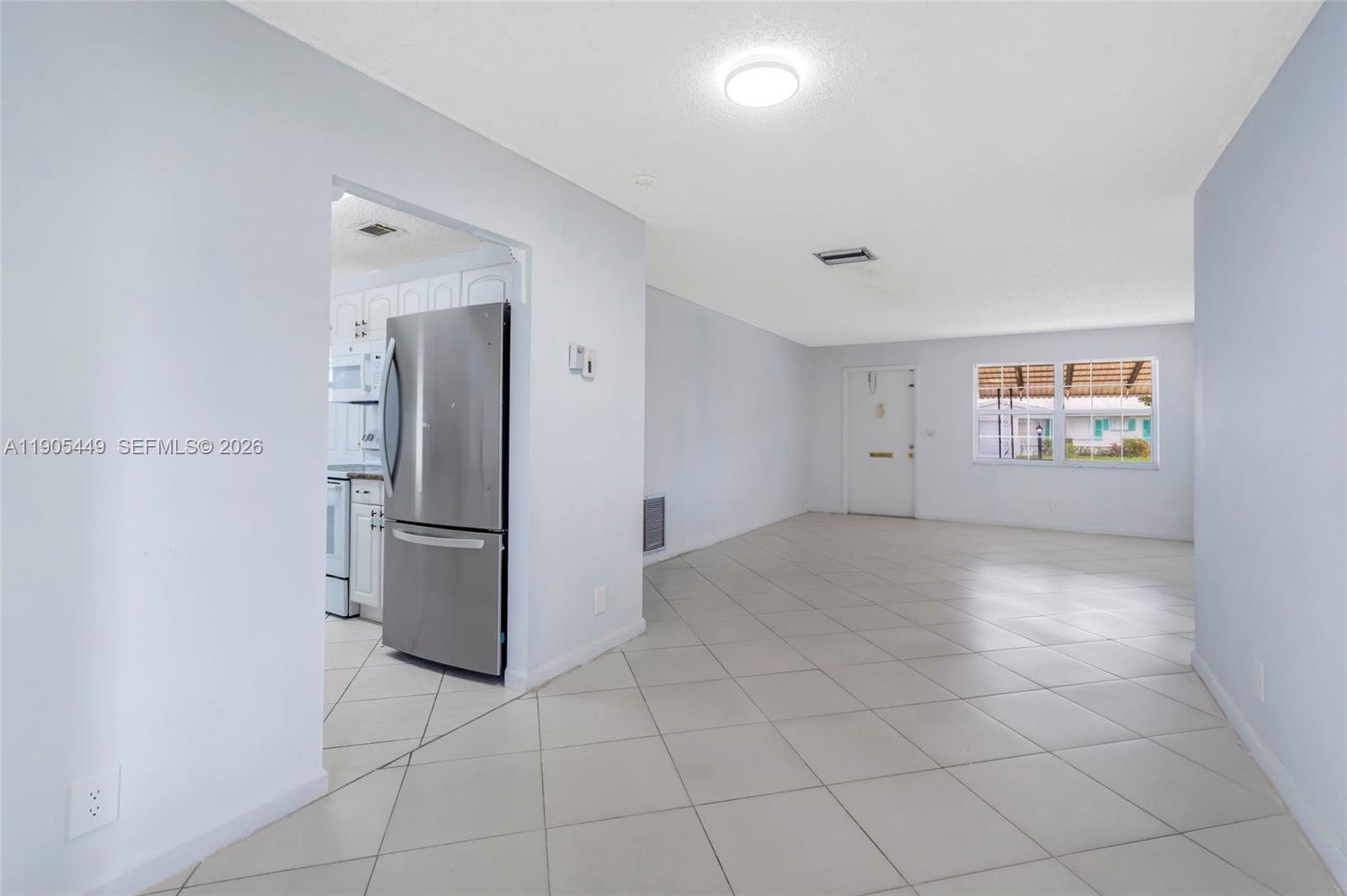 1005 Southwest 18th Street Boynton Beach, FL 33426 - Photo 10 of 44 a view of a refrigerator in kitchen and empty room