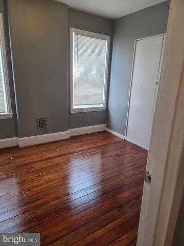 a view of a room with wooden floor