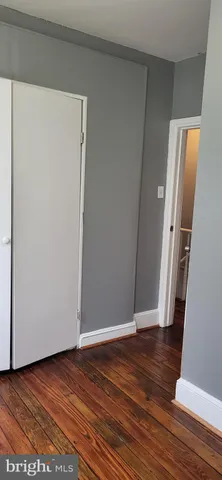 a view of a small space with wooden floor and a window