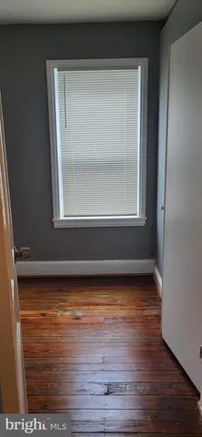a room with water heater and wooden cabinets