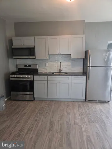 a kitchen with wooden cabinets and a sink