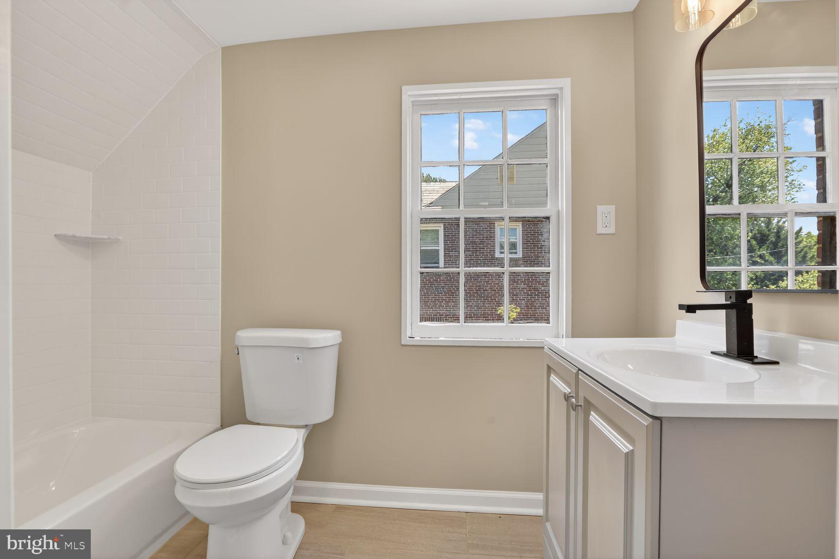 315 East Cold Spring Lane Baltimore, MD 21212 - Photo 19 of 25 a bathroom with a toilet a sink and a window