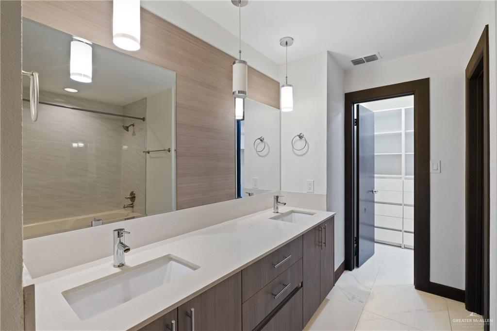 2018 Sabinal Street Mission, TX 78572 - Photo 12 of 20 a bathroom with a double vanity sink mirror and double