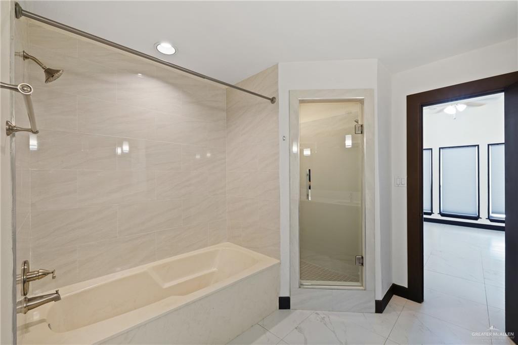 2018 Sabinal Street Mission, TX 78572 - Photo 13 of 20 a bathroom with a bathtub and a shower