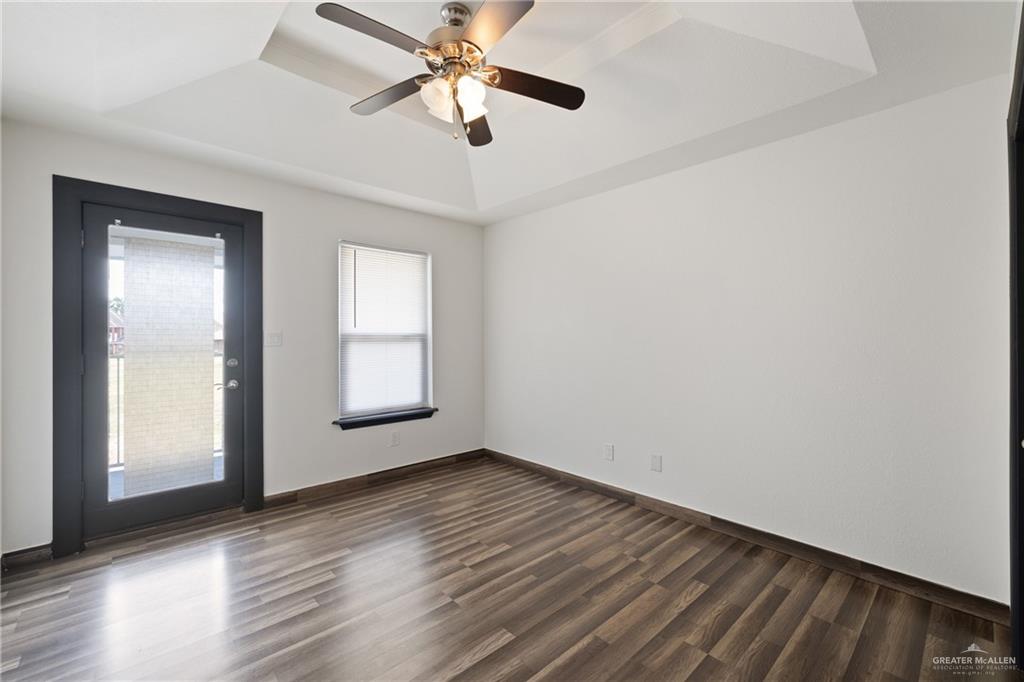 2018 Sabinal Street Mission, TX 78572 - Photo 18 of 20 an empty room with wooden floor chandelier fan and windows