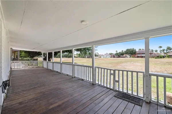 a view of a balcony with wooden floor
