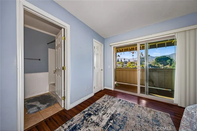 a view of a livingroom with wooden floor and a rug