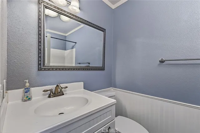 a bathroom with a sink mirror and toilet