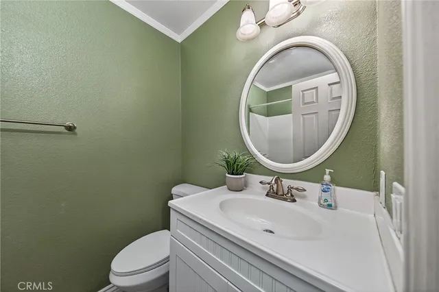 a bathroom with a sink a mirror and toilet